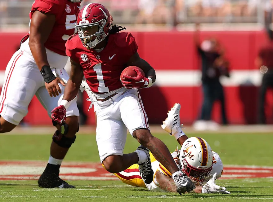 Jahmyr Gibbs of the Alabama Crimson Tide rushes away from Quae Drake of the Louisiana Monroe Warhawks during the first quarter at Bryant-Denny Stadium on September 17, 2022.