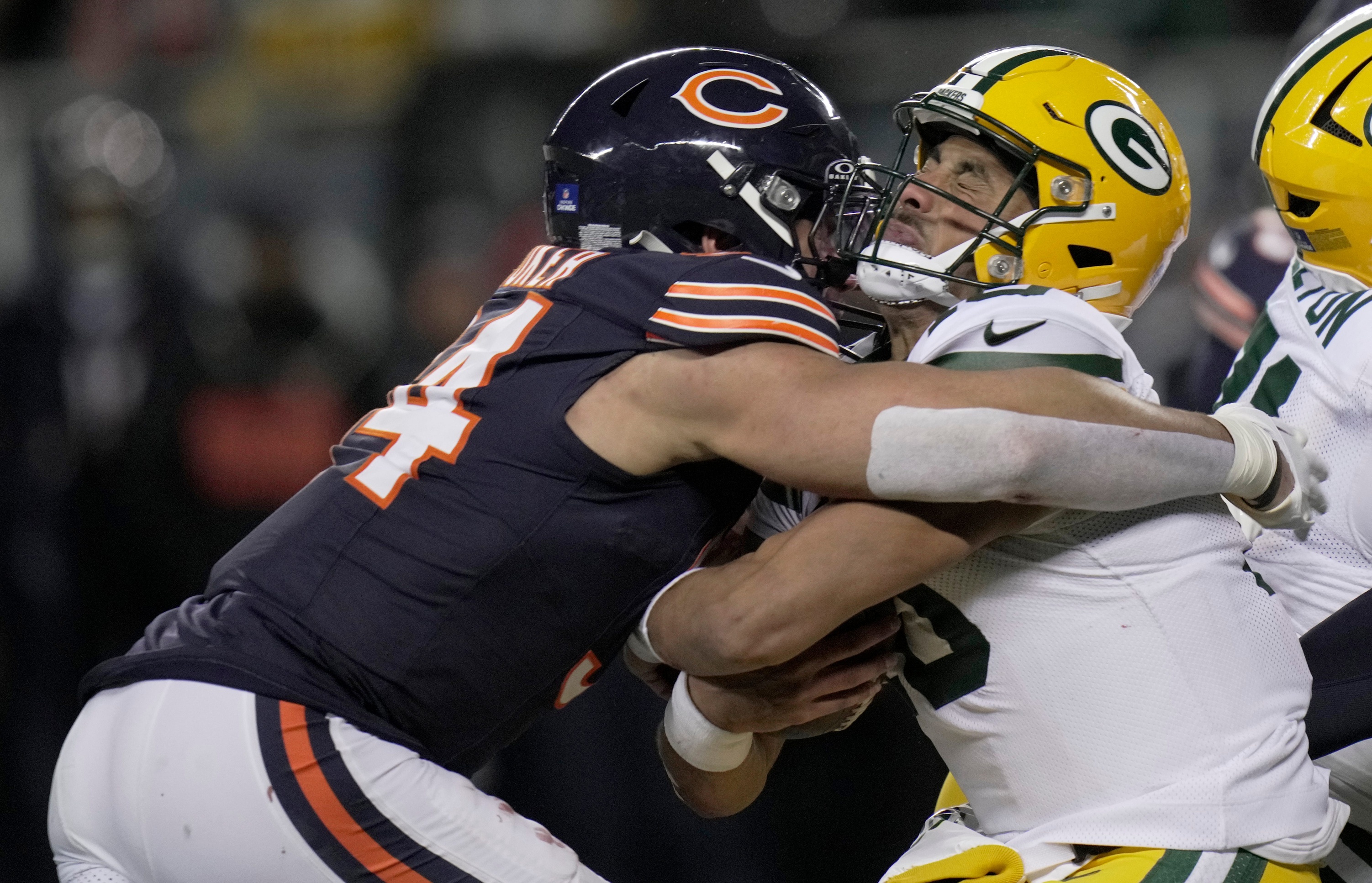 Green Bay Packers QB Jordan Love is sacked by Chicago Bears defensive end Austin Booker as we make our best Packers vs. Bears early prediction.
