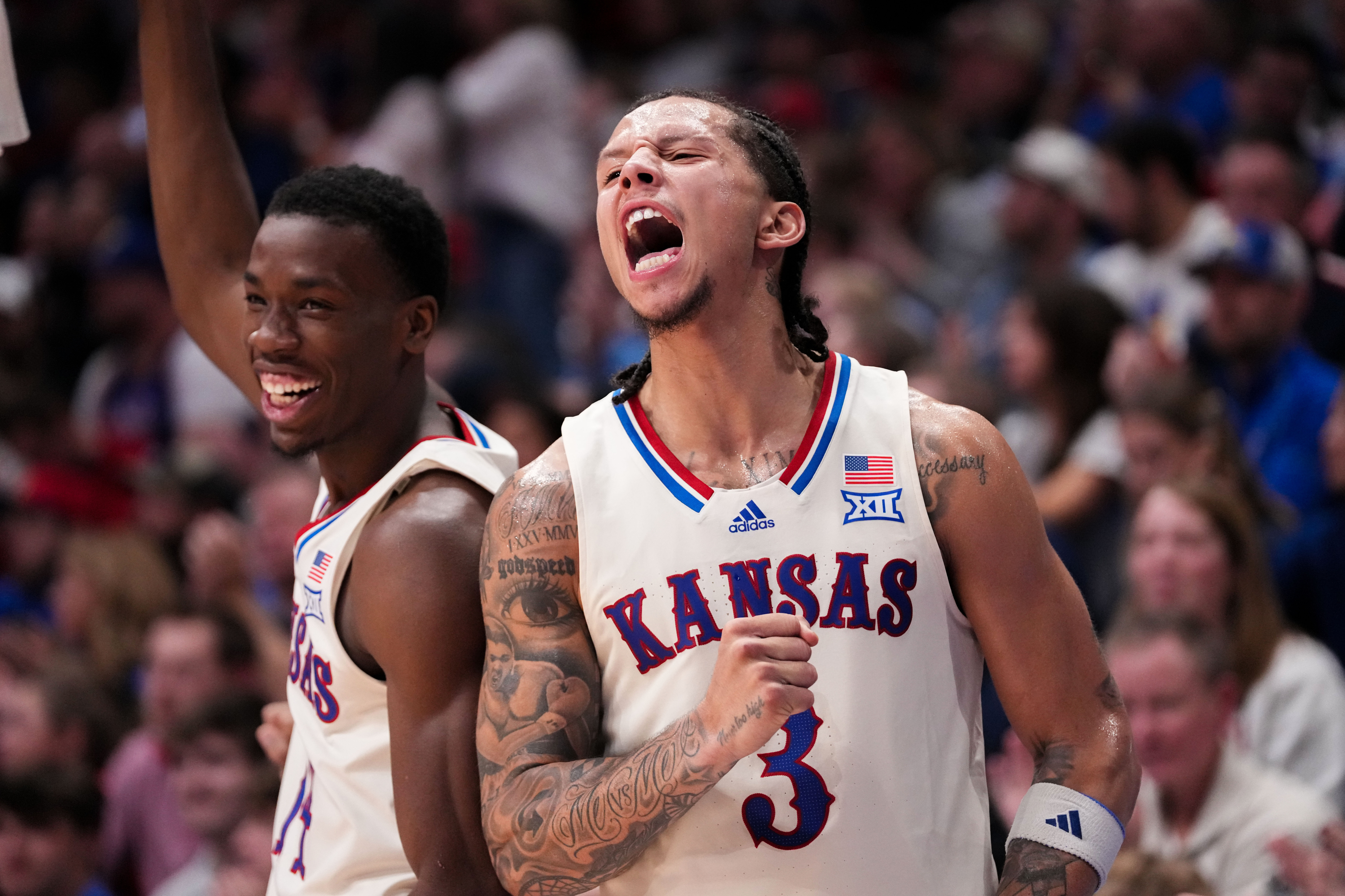 Kansas guards Melvin Council Jr. (14) and Tre White (3) celebrate as we offer our Kansas vs. Kansas State prediction.