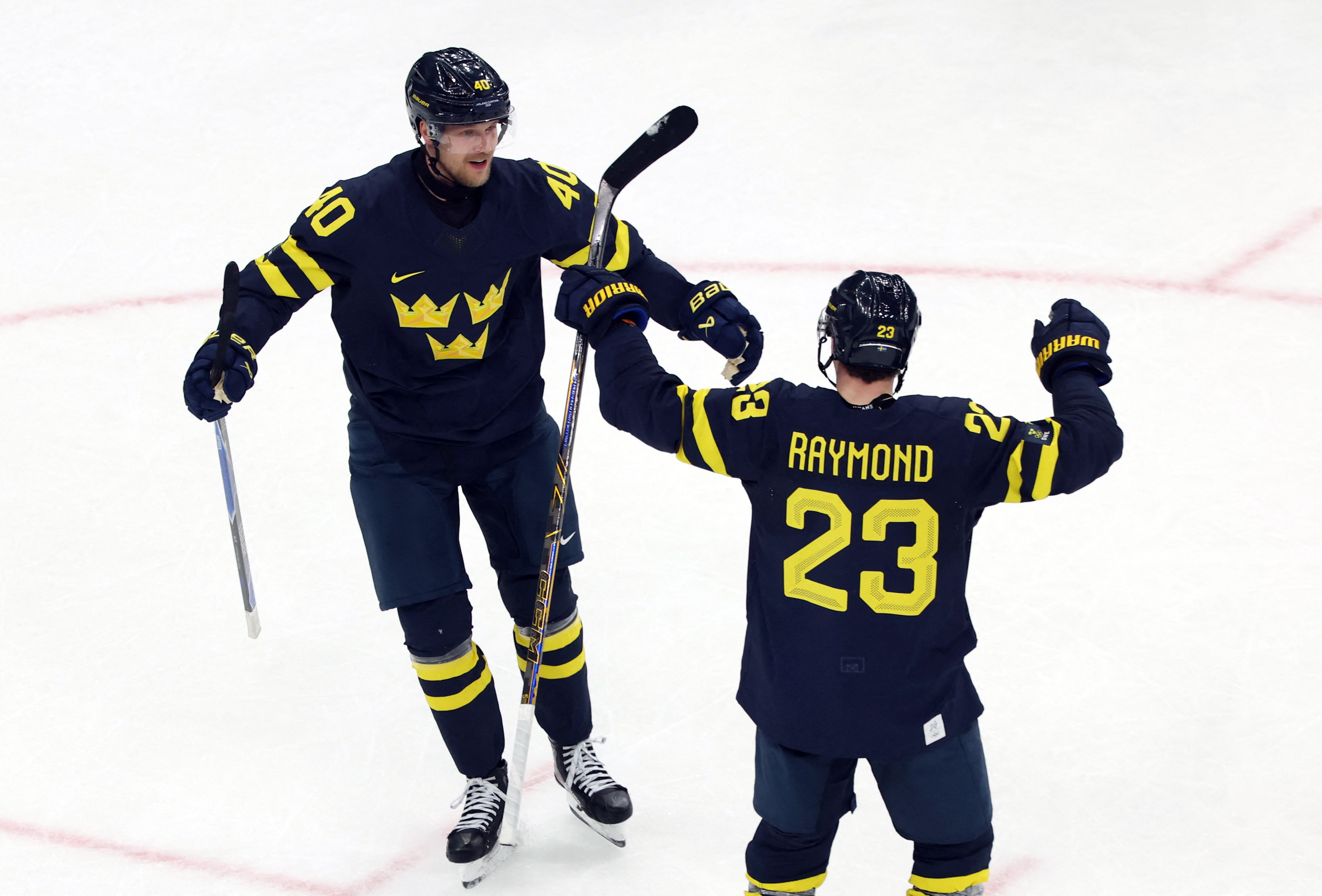 Elias Pettersson and Lucas Raymond celebrate a goal as we provide our Sweden vs. Latvia prediction and best bets. 