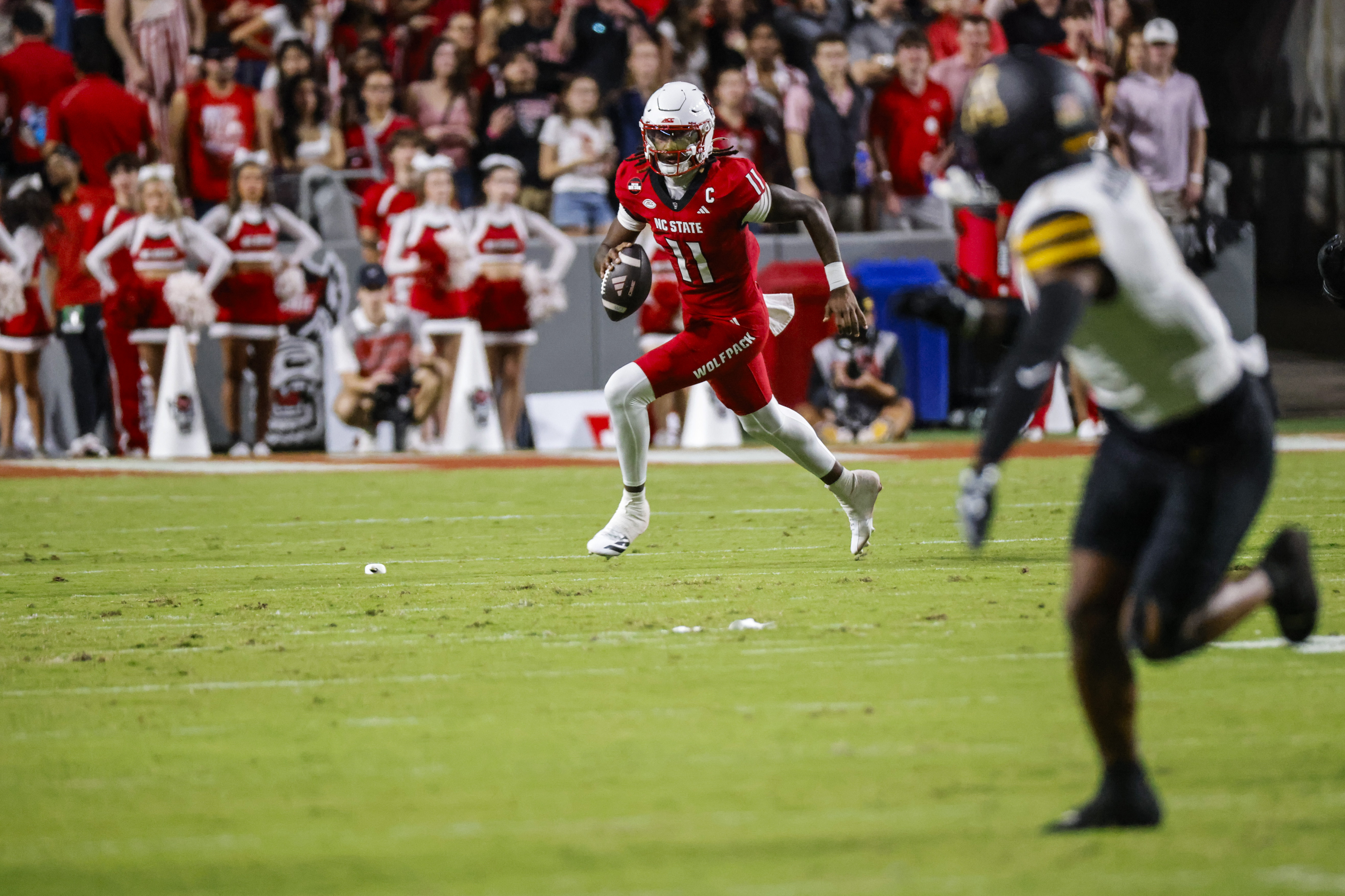 Pictured: Wolfpack QB CJ Bailey in action as we break down our Louisville vs. NC State Prediction. Photo by Jaylynn Nash-Imagn Images.