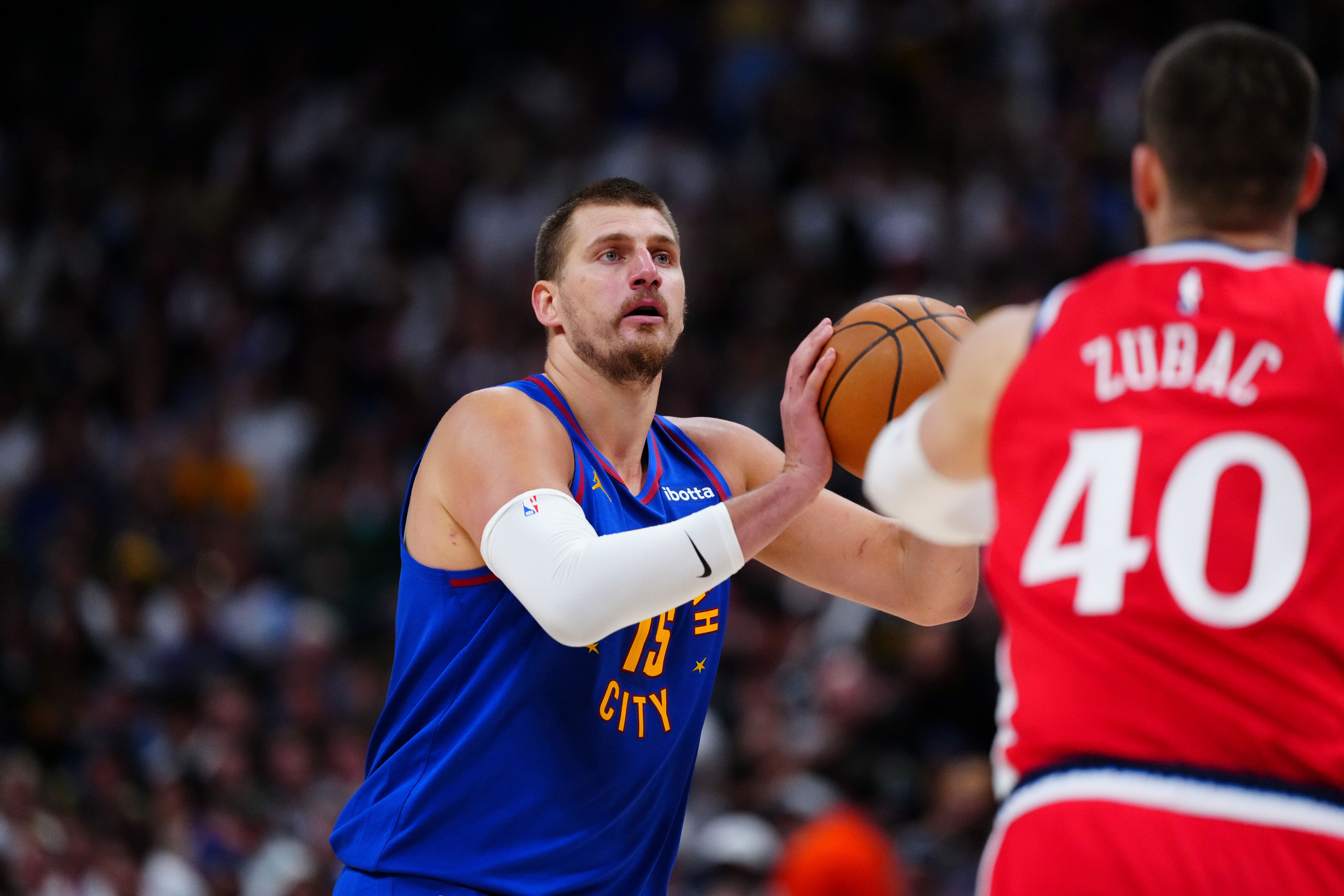 Denver Nuggets center Nikola Jokic (15), seen here lining up a shot, returns tonight against the LA Clippers as we break down the best Nikola Jokic player props.