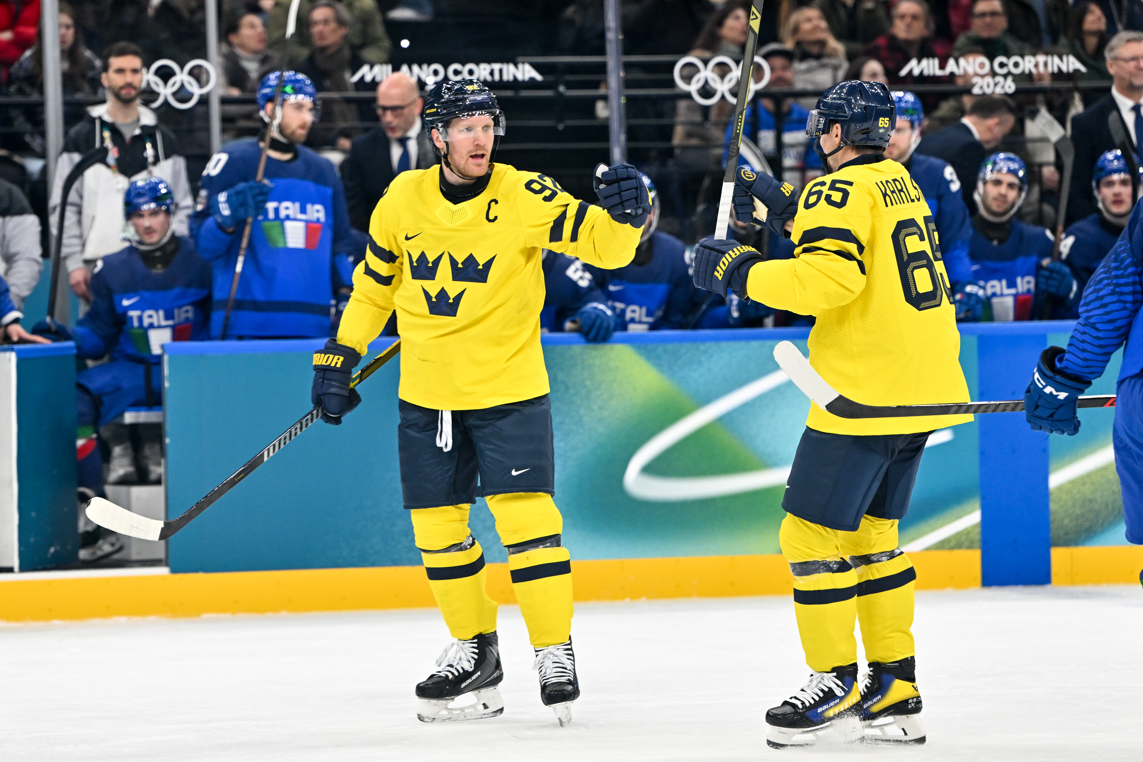 Sweden's Gabriel Landeskog (left) and Erik Karlsson (right) celebrate a goal at the Olympics as we offer our Sweden vs. Latvia prediction.