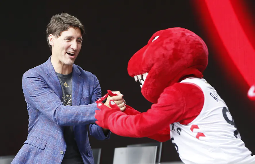 Canadian Prime Minister Justin Trudeau shakes hands with the Toronto Raptors mascot as we look at how Justin Trudeau's resignation has impacted betting markets.