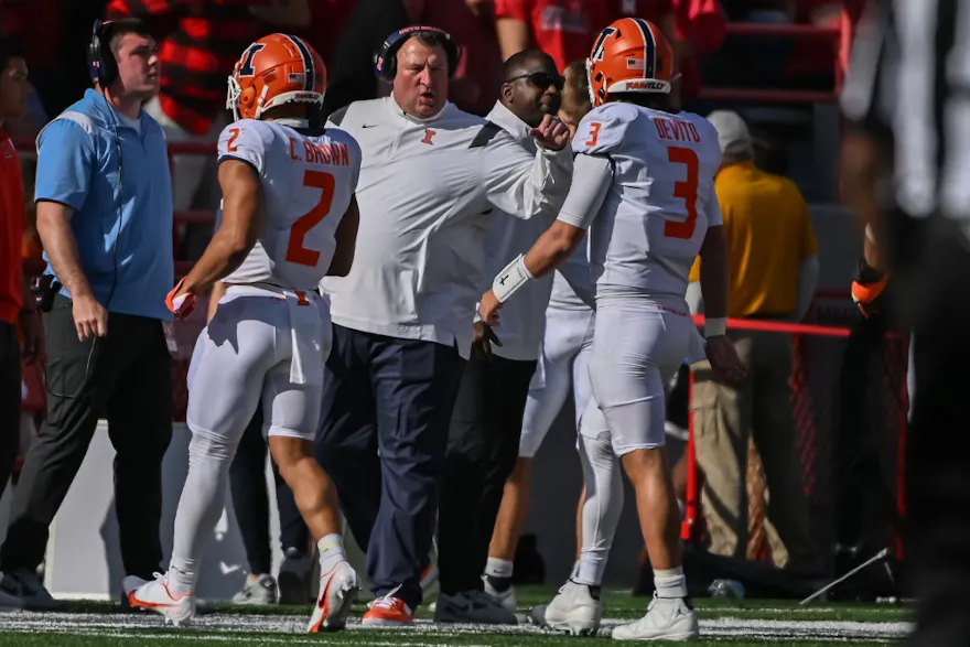 Head coach Bret Bielema of the Illinois Fighting Illini talks with running back Chase Brown and quarterback Tommy DeVito after a drive against the Nebraska Cornhuskers.