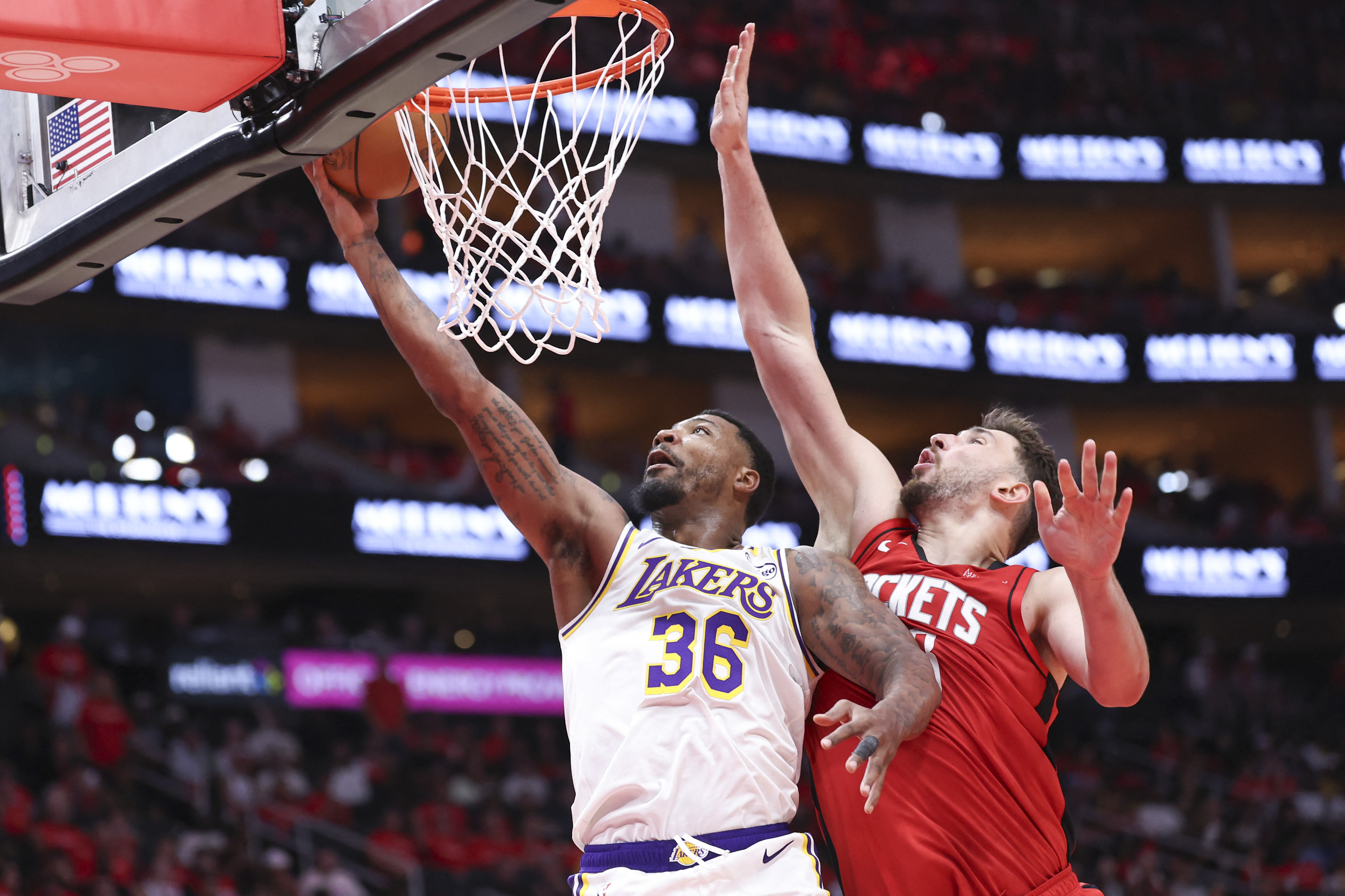 Los Angeles Lakers guard Marcus Smart attempts to score a basket as Houston Rockets center Alperen Sengun - who's featured in my Rockets vs. Lakers player props - defends. 