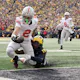 Emeka Egbuka of the Ohio State Buckeyes scores a touchdown against Ja'Den McBurrows of the Michigan Wolverines during the second quarter. The Buckeyes are the opening favorites by the 2024 Big Ten Championship Odds.