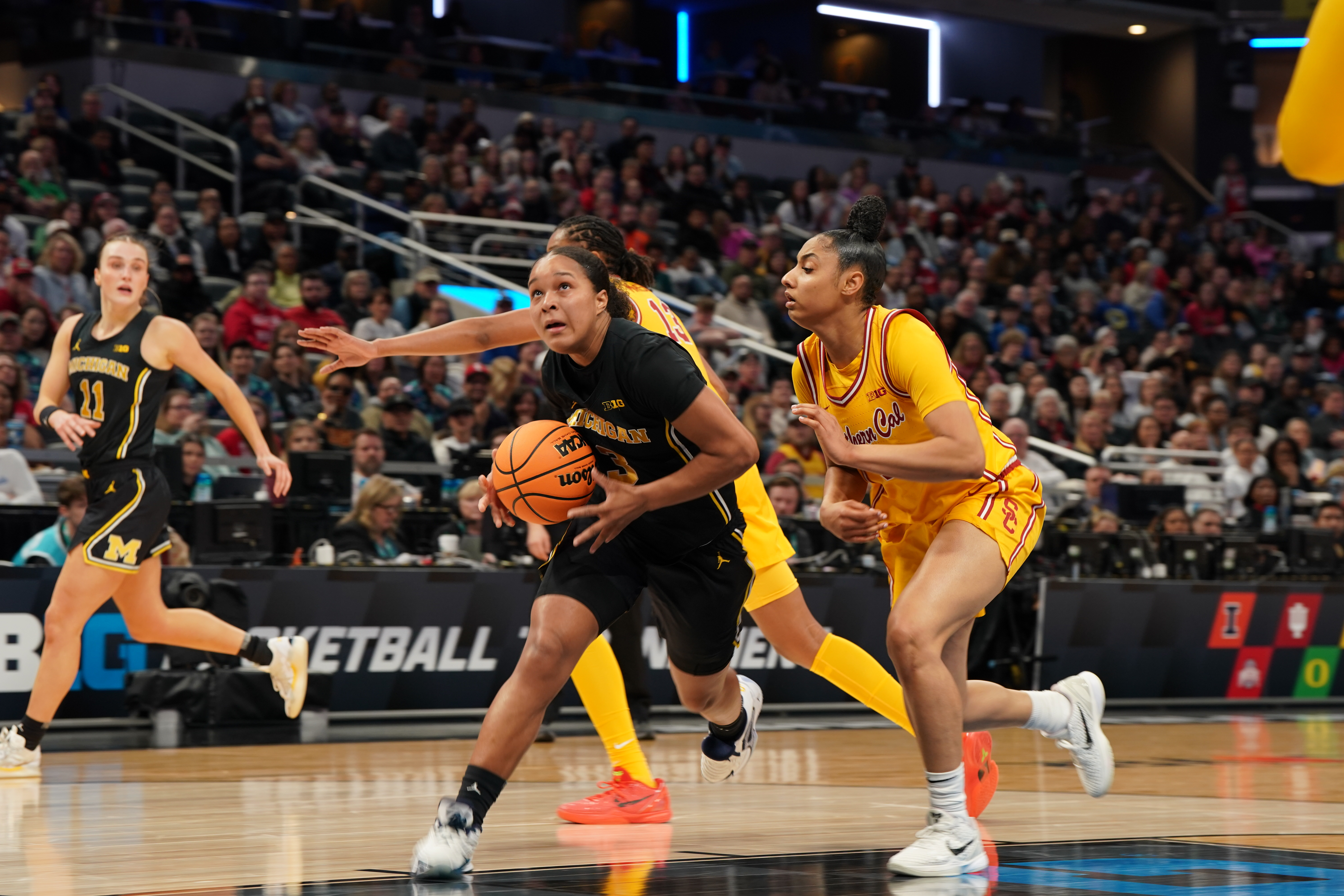 Michigan Wolverines guard Mila Holloway (3) looks to dunk as we break down our Maryland vs. Michigan prediction.