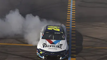 William Byron, driver of the #24 Valvoline Chevrolet, celebrates with a burnout after winning the NASCAR Cup Series United Rentals Work United 500 at Phoenix Raceway on Mar.12, 2023 in Avondale, Arizona.