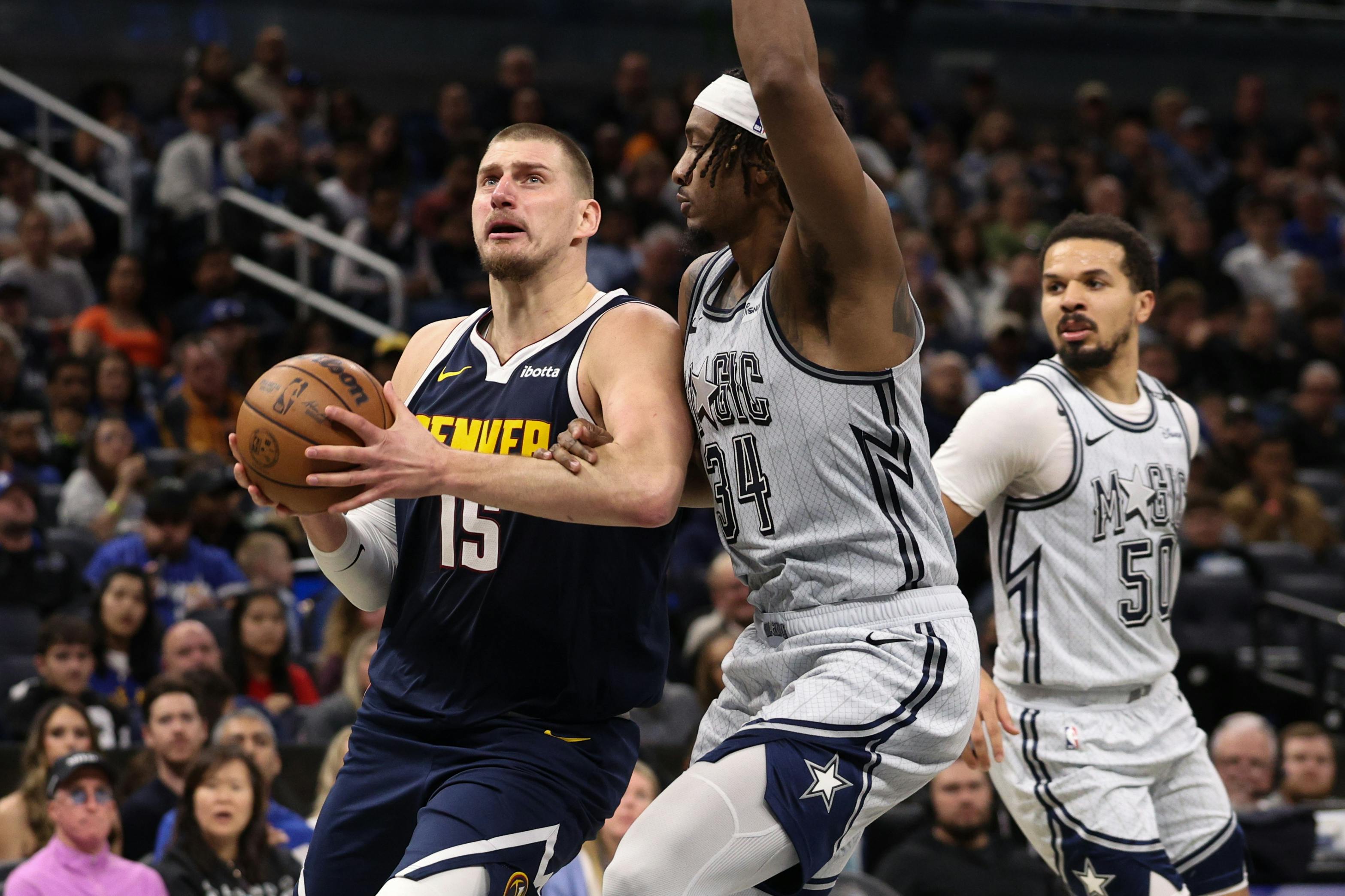 Denver Nuggets center Nikola Jokic drives to the basket against the Orlando Magic as we analyze the 2025 NBA MVP odds. 