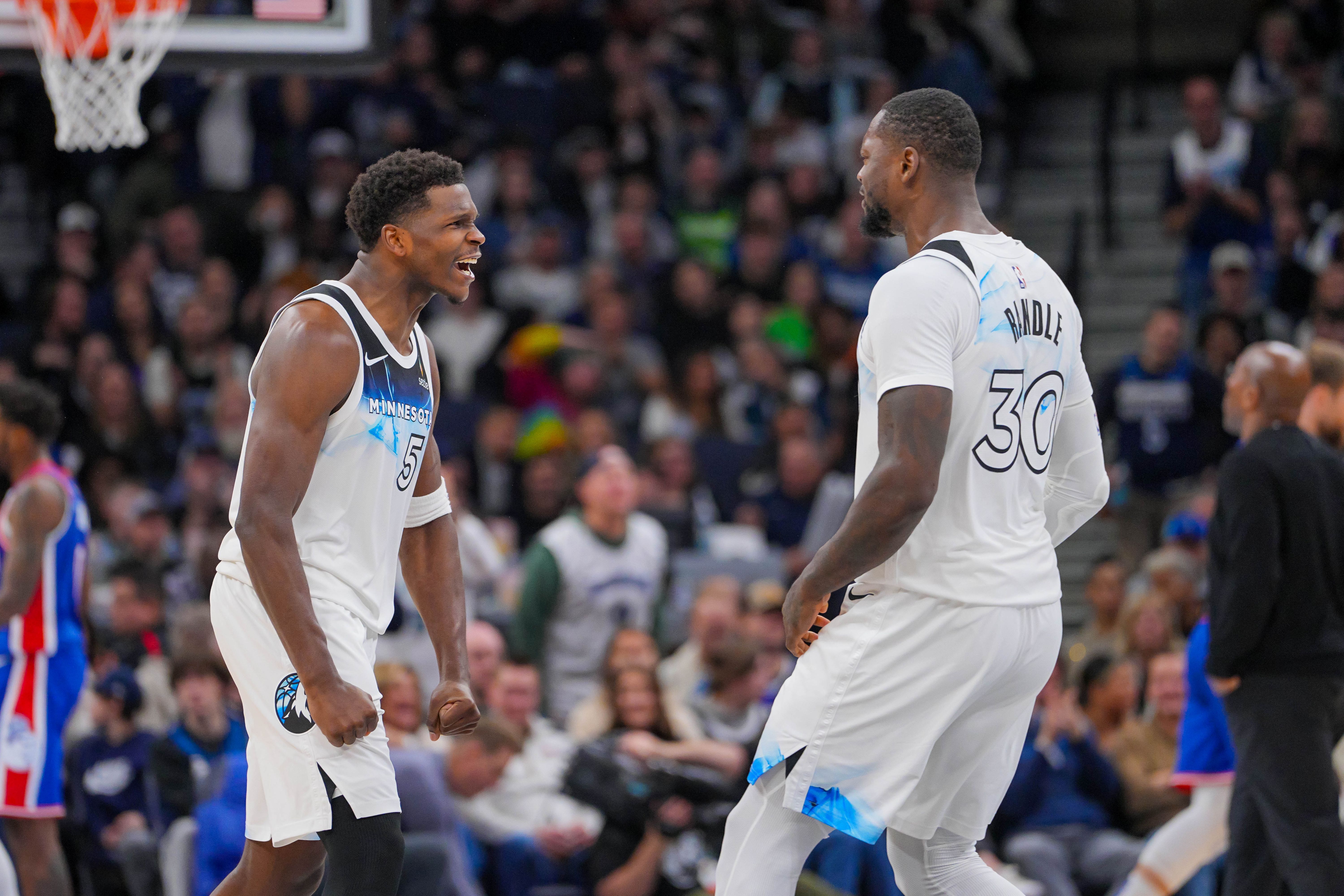 Minnesota Timberwolves guard Anthony Edwards (5) and forward Julius Randle (30) - who are both featured in our Warriors vs. Timberwolves player props - celebrate.
