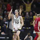 Guard Caitlin Clark #22 of the Iowa Hawkeyes celebrates after a 3-point basket as we take a look at the 2024 Women's Wooden Award odds, favorites, and predictions for the 2023-24 women's basketball season.