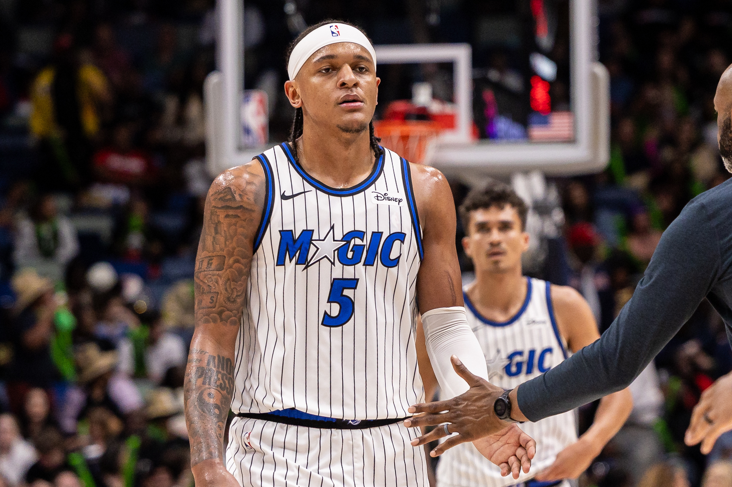 Orlando Magic forward Paolo Banchero (5), seen here looking on during a game, is featured in our Magic vs. Pistons player props for Game 2 tonight.