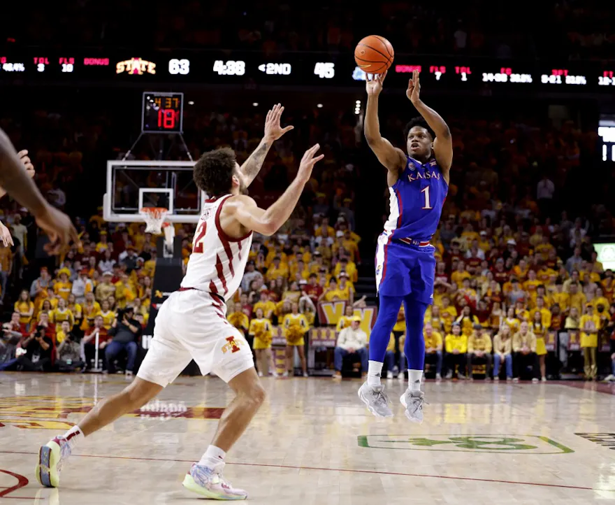 Joseph Yesufu of the Kansas Jayhawks takes a 3-point shot as Gabe Kalscheur of the Iowa State Cyclones defends in the second half of play at Hilton Coliseum on February 4, 2023 in Ames, Iowa. The Iowa State Cyclones won 68-53 over the Kansas Jayhawks.