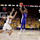 Joseph Yesufu of the Kansas Jayhawks takes a 3-point shot as Gabe Kalscheur of the Iowa State Cyclones defends in the second half of play at Hilton Coliseum on February 4, 2023 in Ames, Iowa. The Iowa State Cyclones won 68-53 over the Kansas Jayhawks.