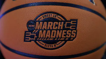 A detail of March Madness Sweet 16 and Elite 8 logos a basketball as we look at how much is expected to be wagered on March Madness
