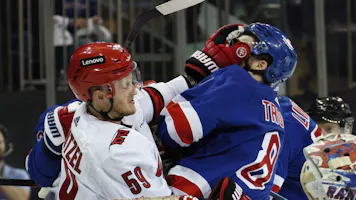 Jake Guentzel (59) of the Carolina Hurricanes gets the glove up on Jacob Trouba (8) of the New York Rangers, as we offer our best Rangers vs. Hurricanes predictions and expert picks for Thursday's Game 3 at PNC Arena in Raleigh, N.C.