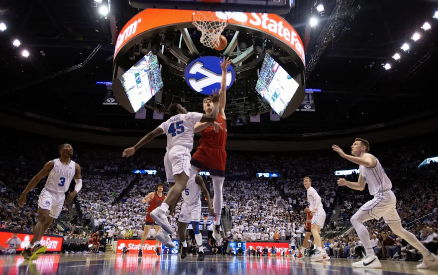Mitchell Saxen of the Saint Mary's Gaels shoots over Fousseyni Traore, Rudi Williams and Spencer Johnson of the Brigham Young Cougars on Jan. 28, 2023 at the Marriott Center in Provo, Utah.