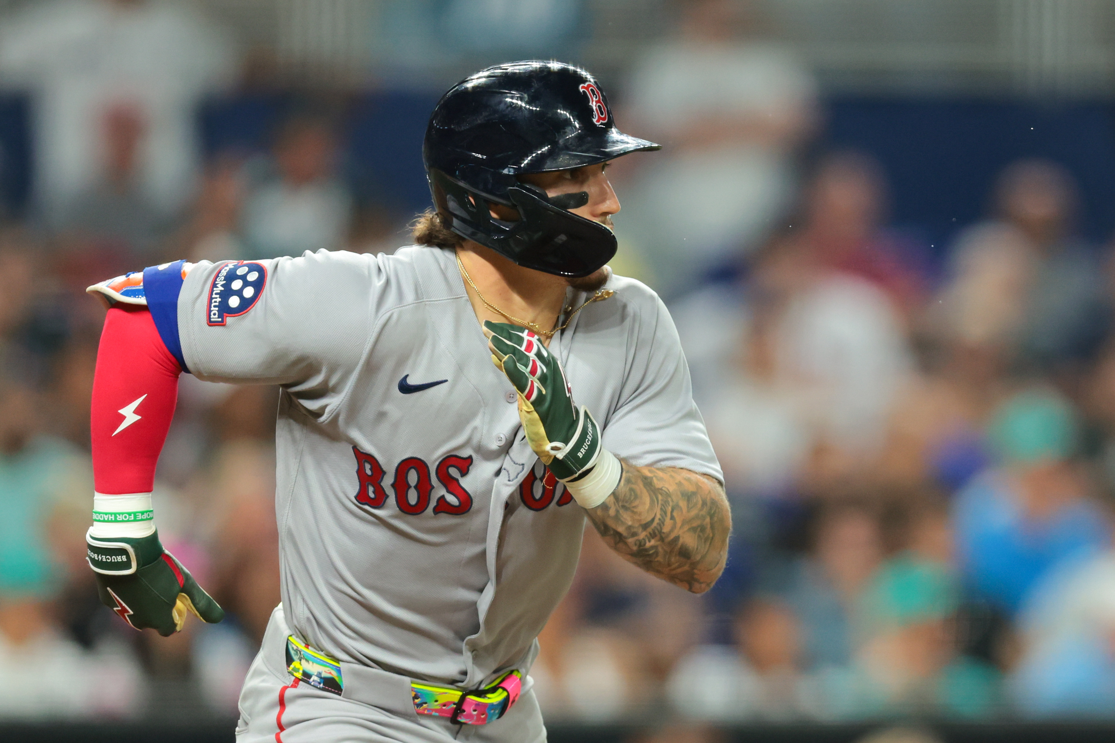 Boston Red Sox left fielder Jarren Duran (16) runs toward first base after hitting a single against the Miami Marlins during the sixth inning at loanDepot Park. 
