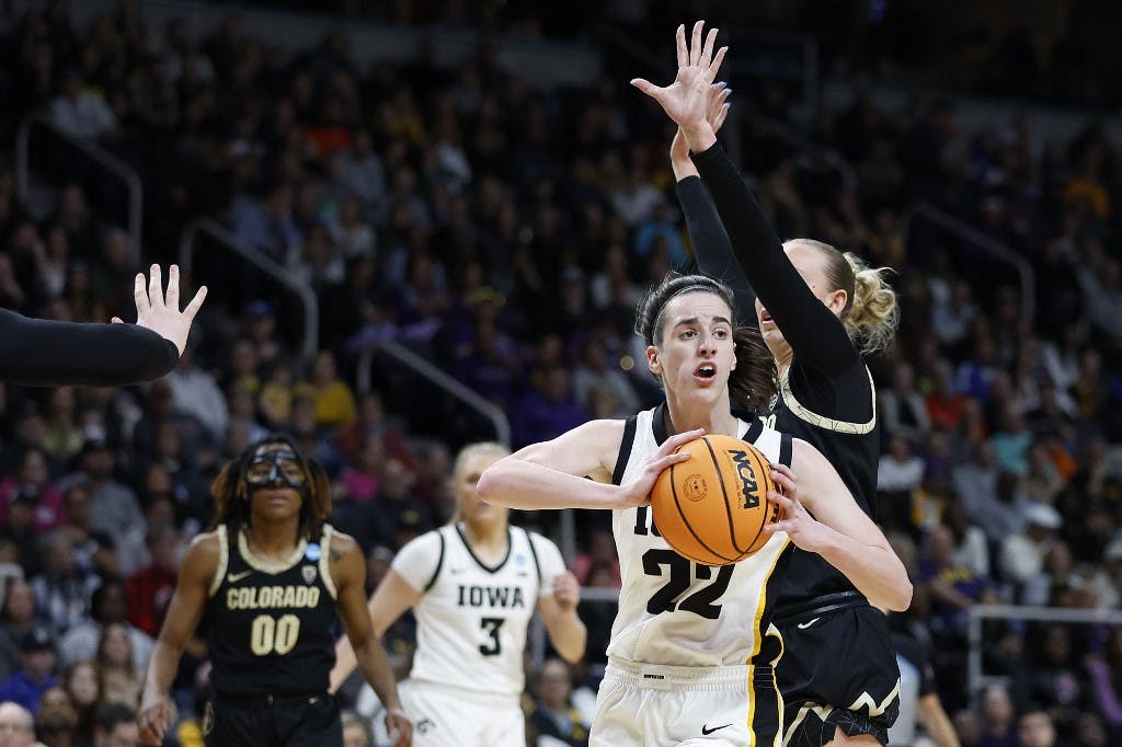 Caitlin Clark #22 of the Iowa Hawkeyes looks to pass against the Colorado Buffaloes during the first half in the Sweet 16 round of the NCAA Women