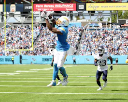 Keenan Allen of the Los Angeles Chargers catches a touchdown against the Tennessee Titans as we share our favorite Raiders vs. Chargers prediction.
