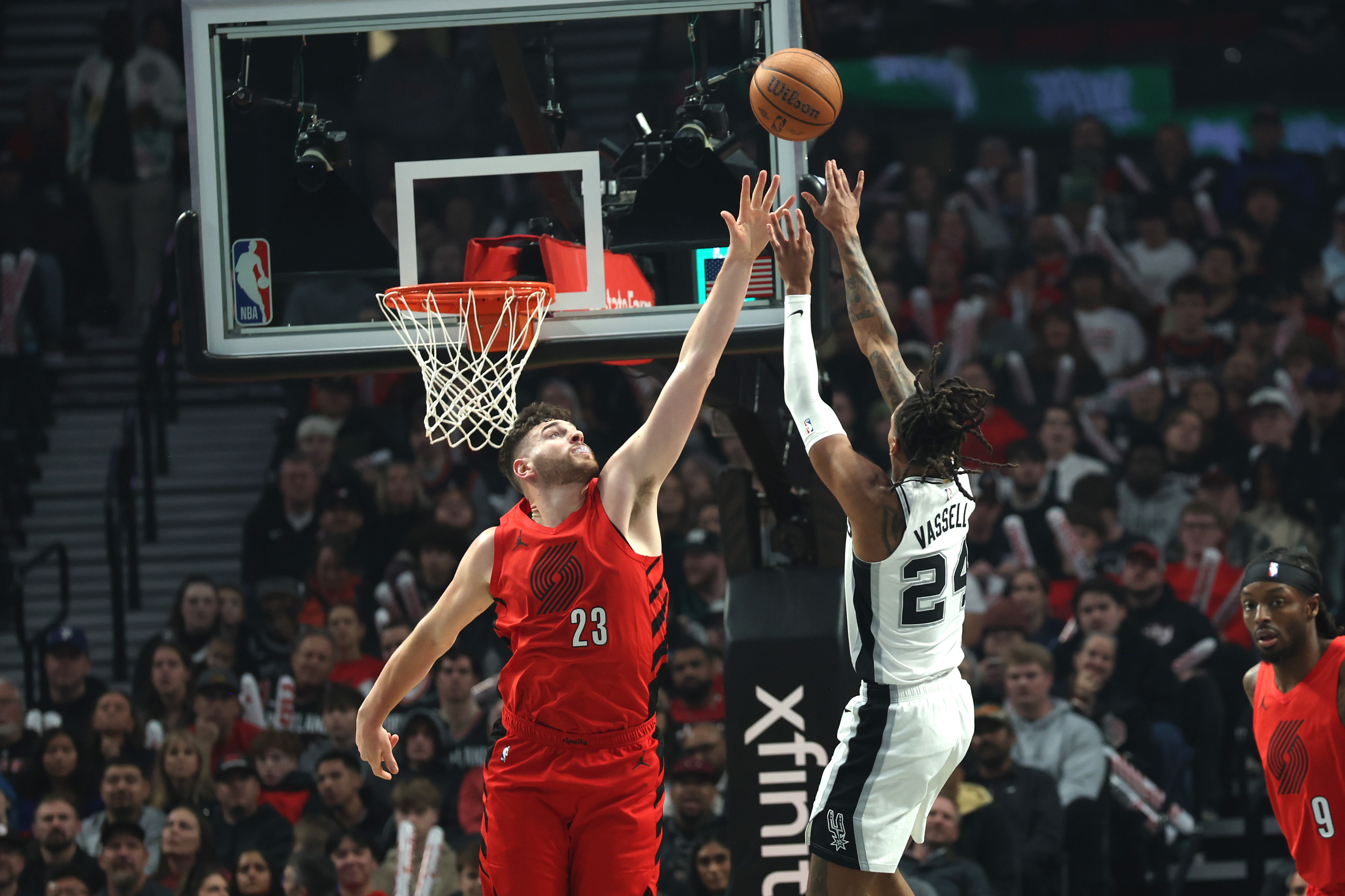 San Antonio Spurs guard/forward Devin Vassell (24) shoots the ball over Portland Trail Blazers center Donovan Clingan (23) in the first half at Moda Center.