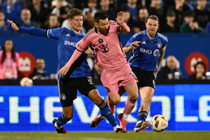 Lionel Messi dribbles the ball between Joaquín Sosa and Samuel Piette of CF Montréal as we make our best Lionel Messi and game predictions for the May 15 clash featuring Orlando City SC and Inter Miami. 