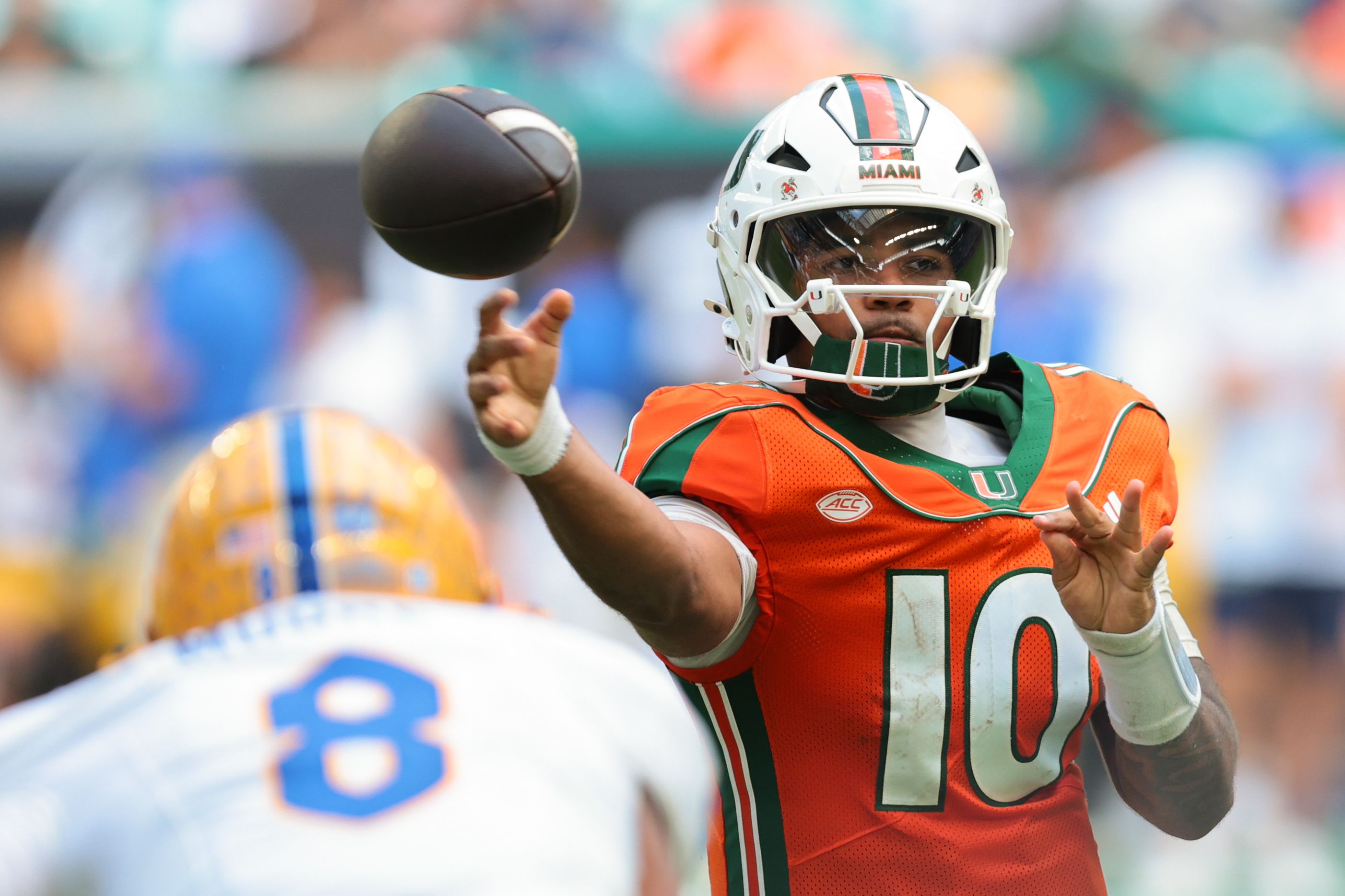  Miami Gardens, Florida, USA; Miami Hurricanes quarterback Darian Mensah (10) throws a pass to the Pittsburgh Panthers as we examine the College Football Playoff odds.