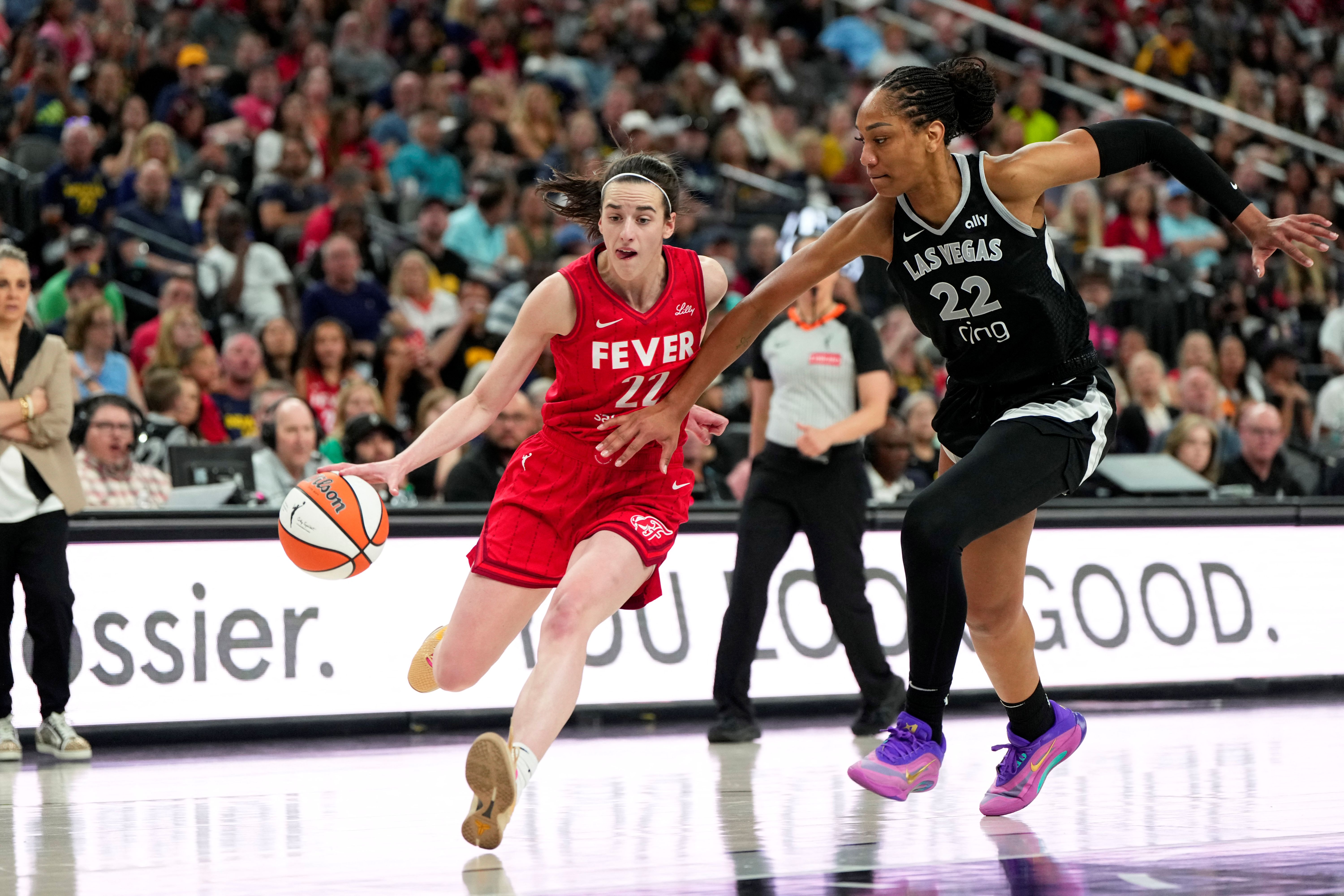 Indiana Fever guard Caitlin Clark (22) dribbles the ball against Las Vegas Aces center A'ja Wilson (22) as we break down the WNBA championship odds 2026.