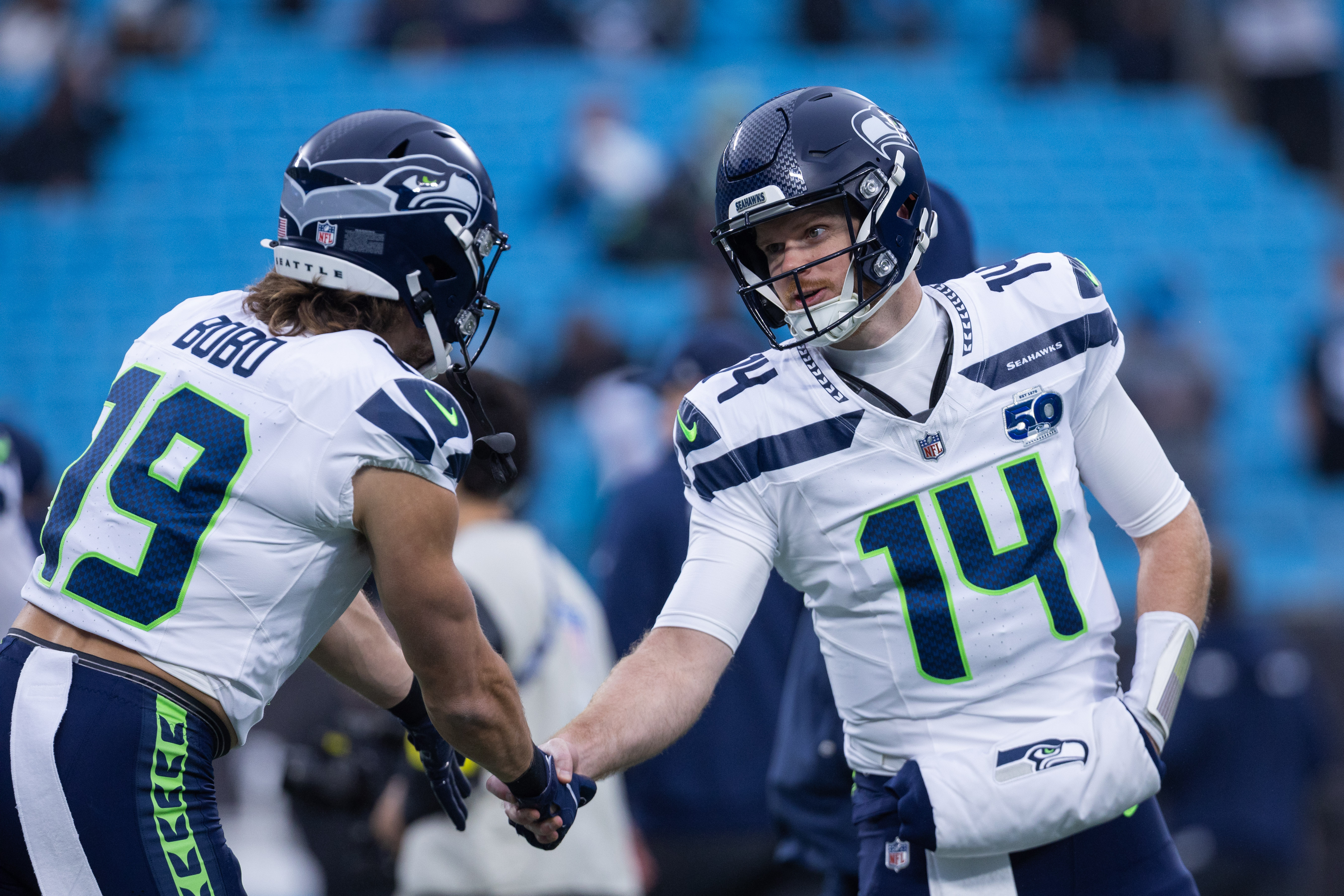 Seattle Seahawks quarterback Sam Darnold (14) and wide receiver Jake Bobo (19) shake hands as we break down our 49ers vs. Seahawks predictions.