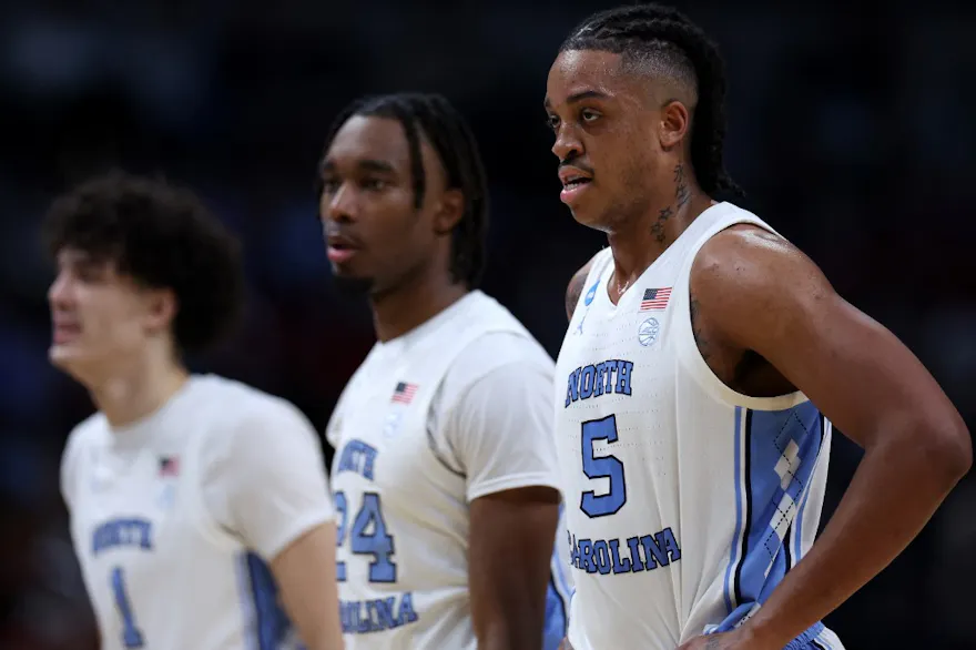 Armando Bacot, Jae'Lyn Withers, and Zayden High of the North Carolina Tar Heels look on against the Alabama Crimson Tide.