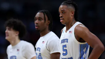 Armando Bacot, Jae'Lyn Withers, and Zayden High of the North Carolina Tar Heels look on against the Alabama Crimson Tide.
