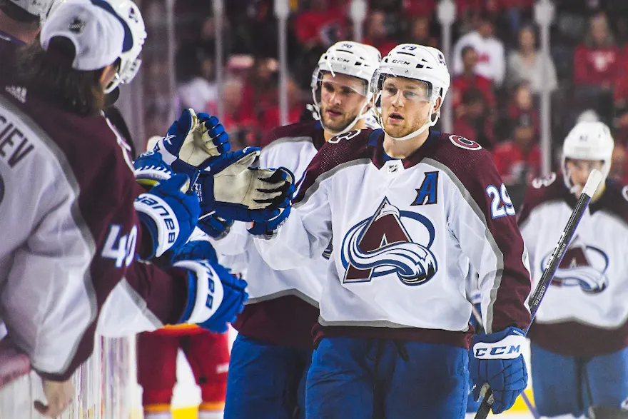 Nathan MacKinnon of the Colorado Avalanche celebrates with the bench after scoring against the Calgary Flames.