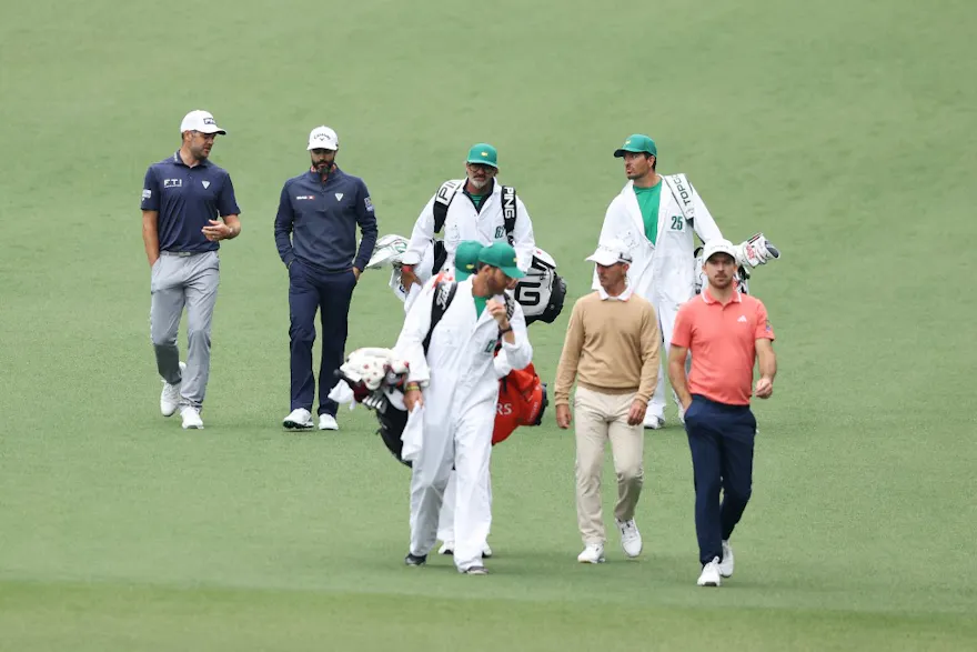 Canadians Nick Taylor, Mike Weir, Adam Hadwin, and Corey Conners walk down the second fairway during a practice round prior to the 2024 Masters Tournament as we look at our top Canadian golfer Masters picks.