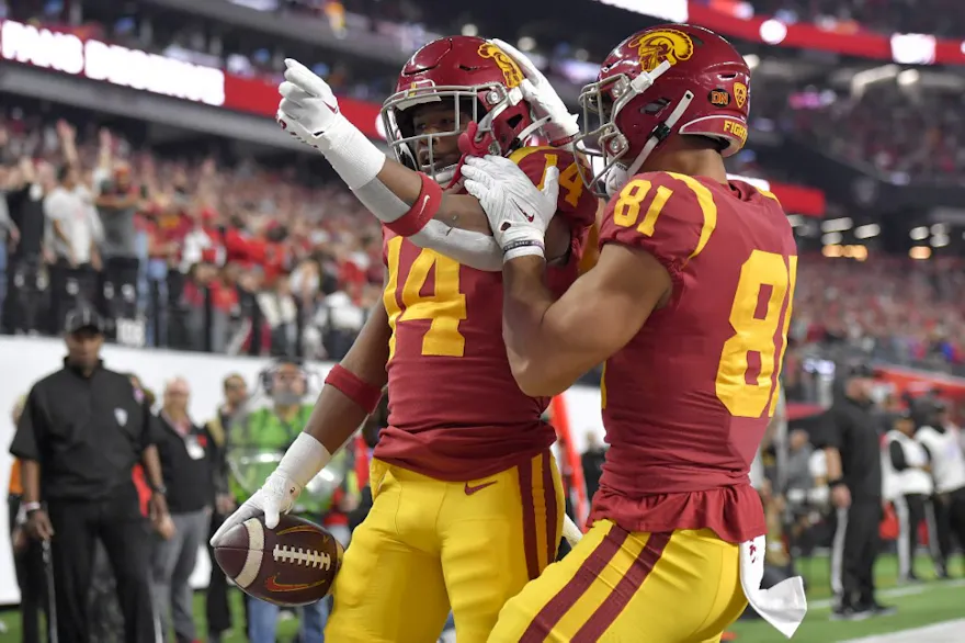 Raleek Brown of the USC Trojans celebrates with teammate Kyle Ford #81 after scoring a touchdown against the Utah Utes during the first quarter in the Pac-12 Championship at Allegiant Stadium on December 02, 2022 in Las Vegas, Nevada.