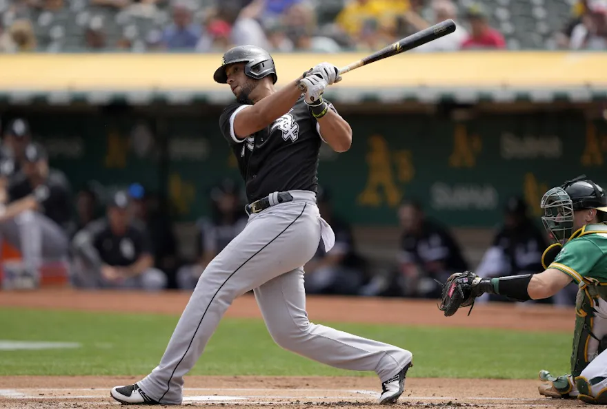 Jose Abreu of the Chicago White Sox hits an RBI double scoring Andrew Vaughn against the Oakland Athletics in the top of the first inning at RingCentral Coliseum on September 11, 2022 in Oakland, California.