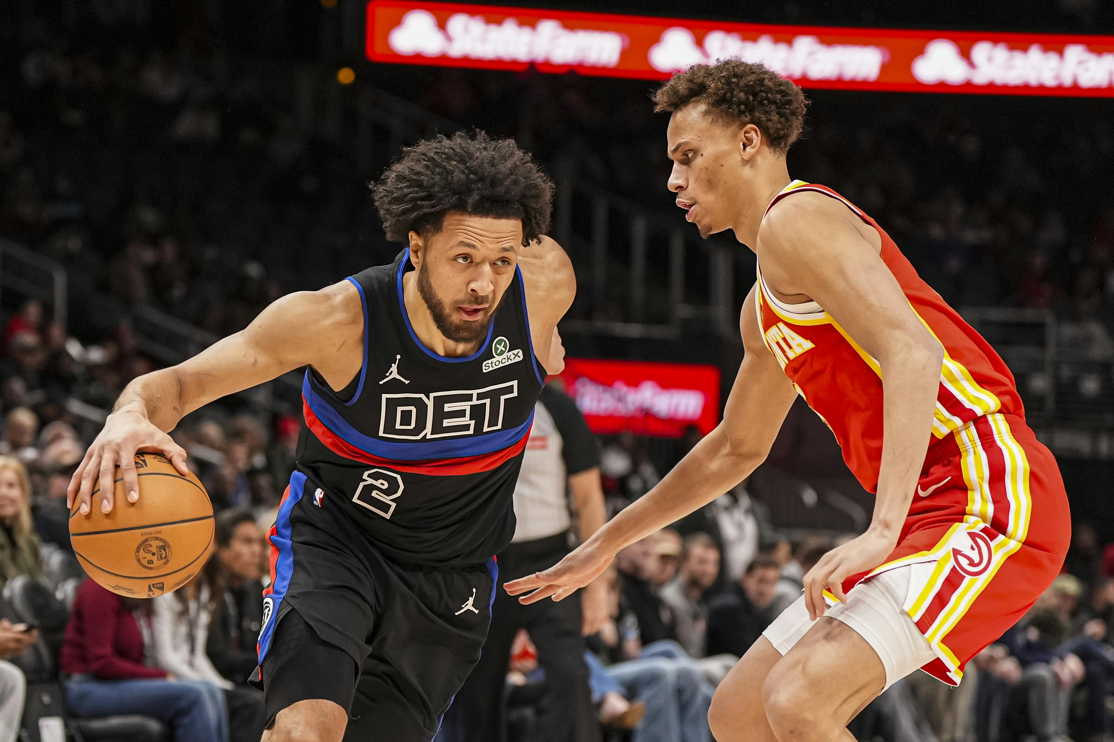 Detroit Pistons guard Cade Cunningham dribbles against Atlanta Hawks guard Dyson Daniels. Cunningham leads the NBA Most Improved Player odds.