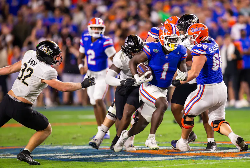 Florida Gators running back Montrell Johnson Jr. breaks through a hole as we offer our Florida vs. Tennessee prediction.