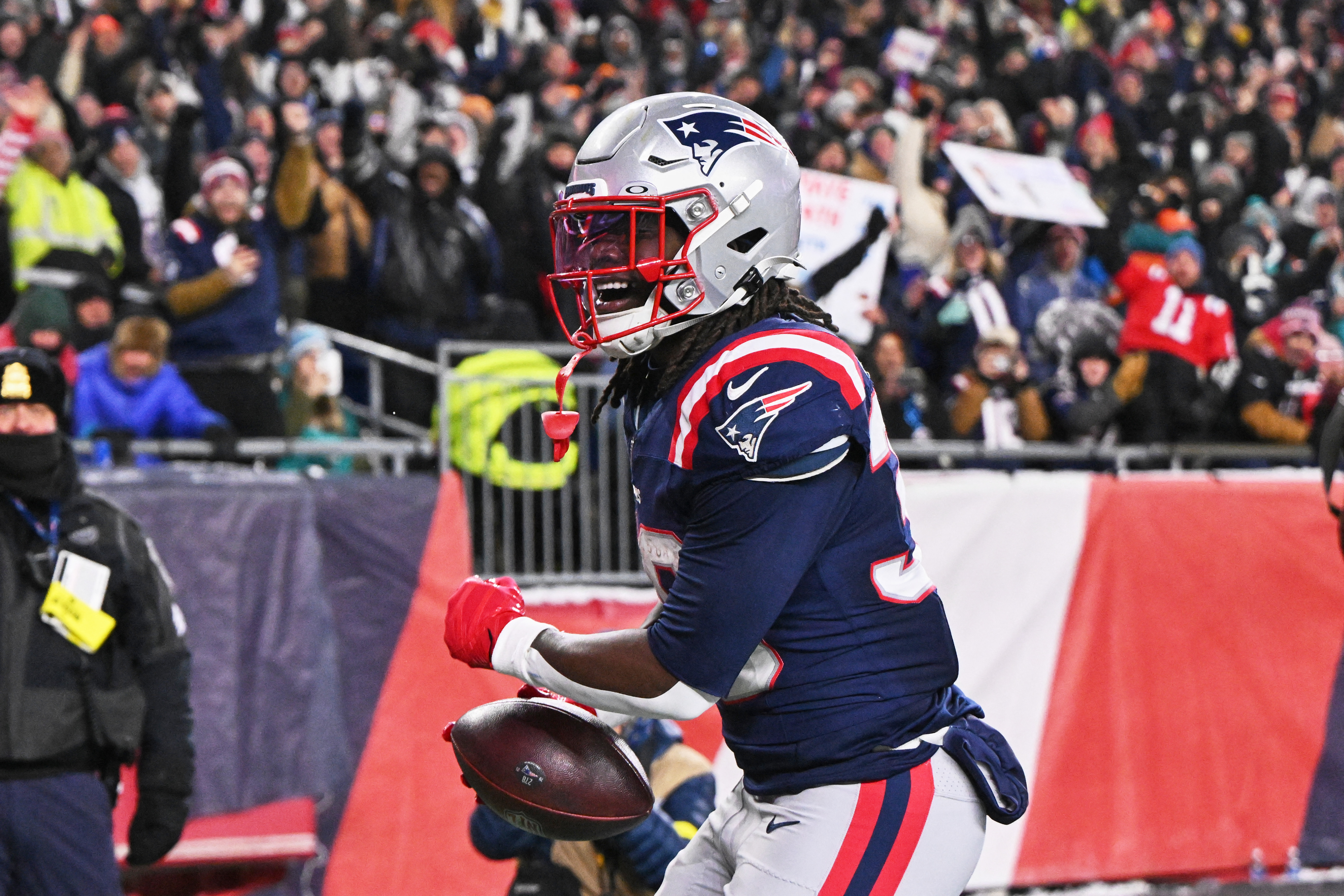 New England Patriots running back Rhamondre Stevenson (38) reacts after catching a fifteen-yard touchdown pass as we break down our Texans vs. Patriots predictions.