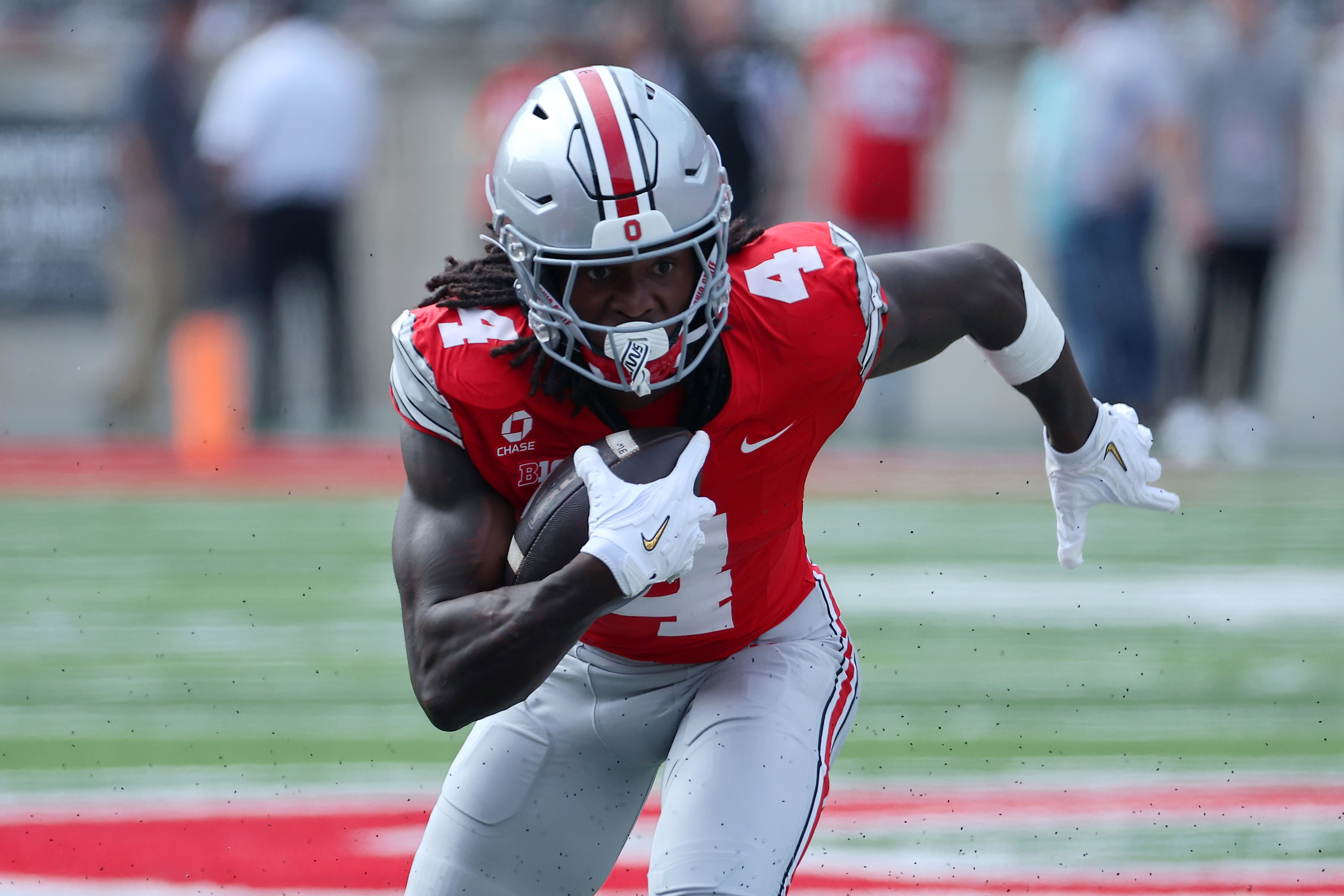 Ohio State Buckeyes wide receiver Jeremiah Smith (4) runs after making the catch as we take a closer look at the 2026-2027 Heisman odds.