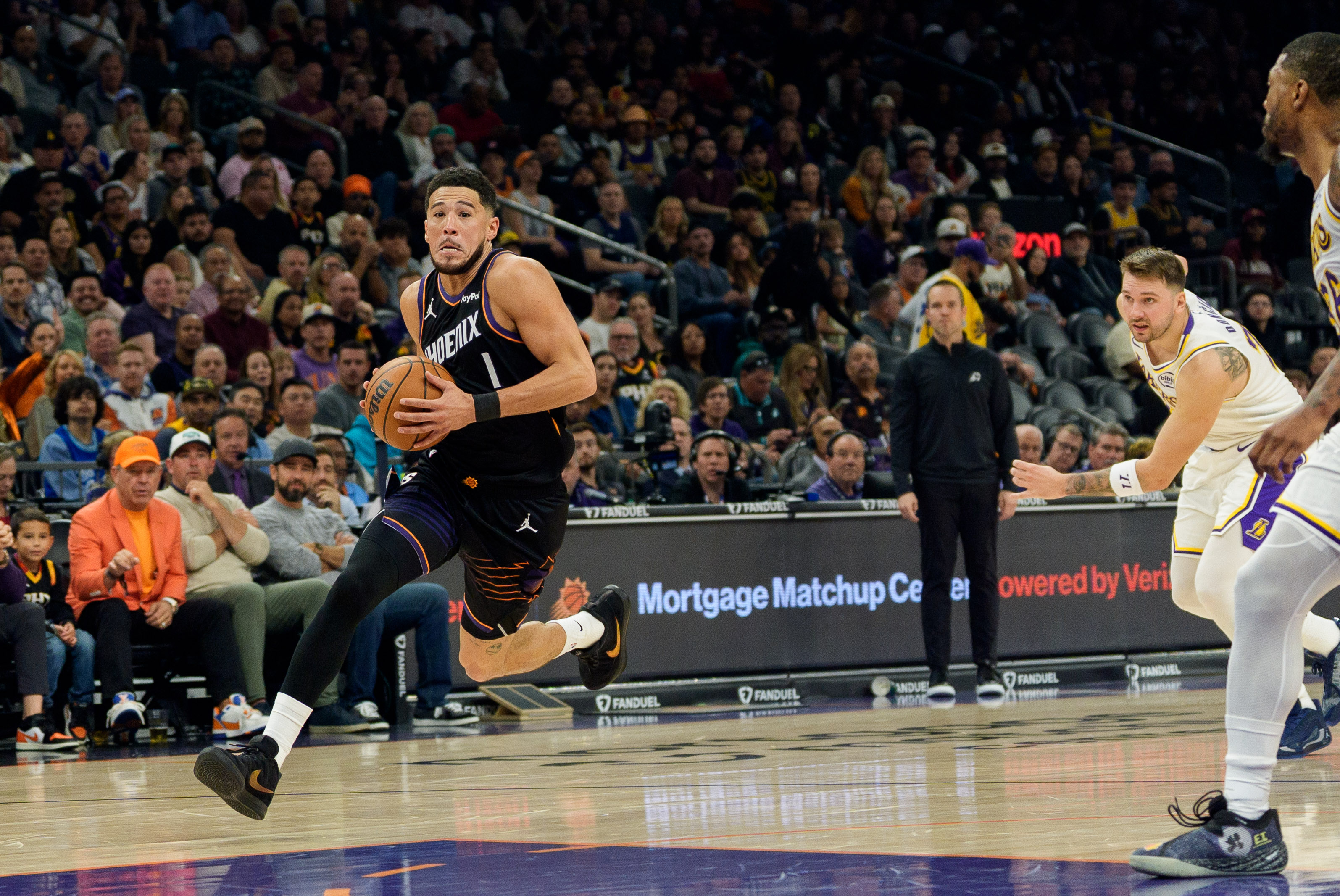 Phoenix Suns guard Devin Booker drives to the basket as we make our best Warriors vs. Suns player prop bets