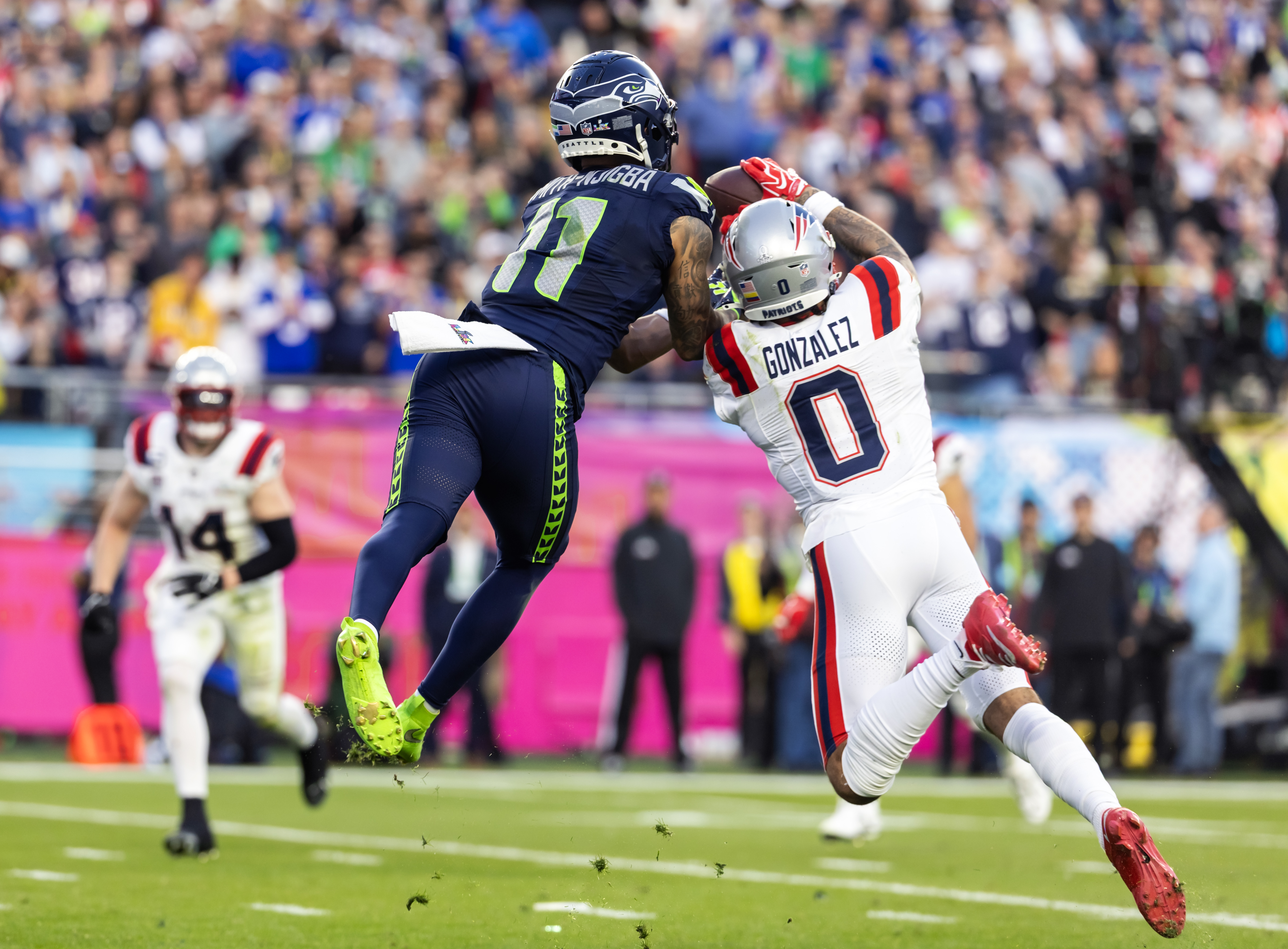New England Patriots cornerback Christian Gonzalez (0) breaks up a pass against Seattle Seahawks wide receiver Jaxon Smith-Njigba (11) during Super Bowl LX at Levi's Stadium.