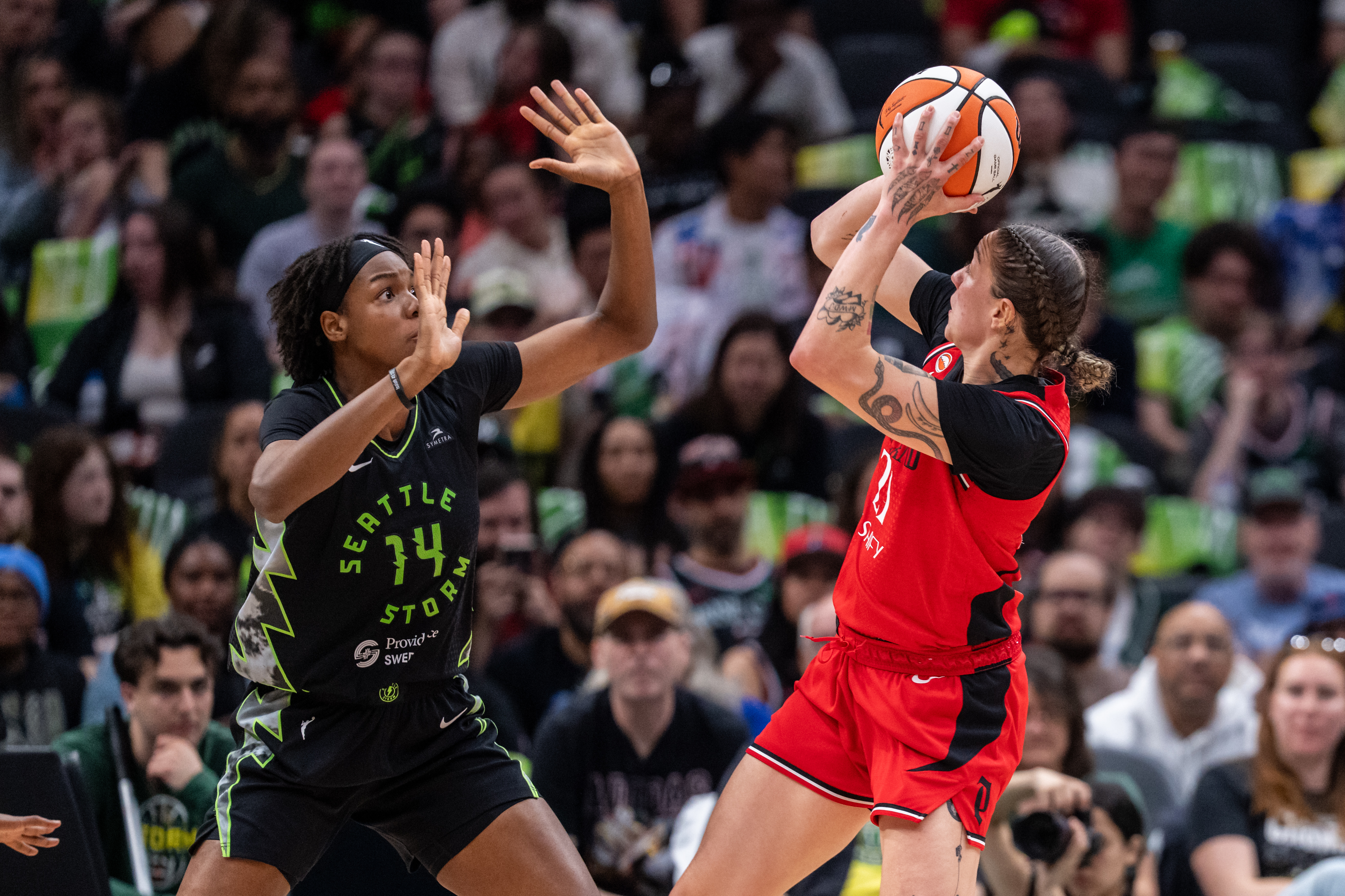 Portland Fire forward Emily Engstler (21) shoots over Seattle Storm center Dominique Malonga (14) as we break down our Fire vs. Storm prediction.