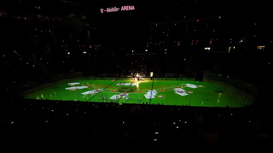 An image of a blackjack table is projected on the ice as we look at Caesars blackjack partnership with the NHL