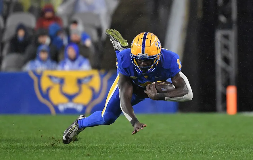Israel Abanikanda of the Pittsburgh Panthers falls as he carries the ball in the second quarter of the game against the Georgia Tech Yellow Jackets at Acrisure Stadium on October 1, 2022 in Pittsburgh, Pennsylvania.