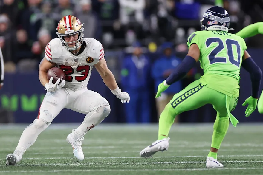 Christian McCaffrey of the San Francisco 49ers carries the ball ahead of our Week 13 NFL Sunday Night Football predictions for 49ers vs. Eagles