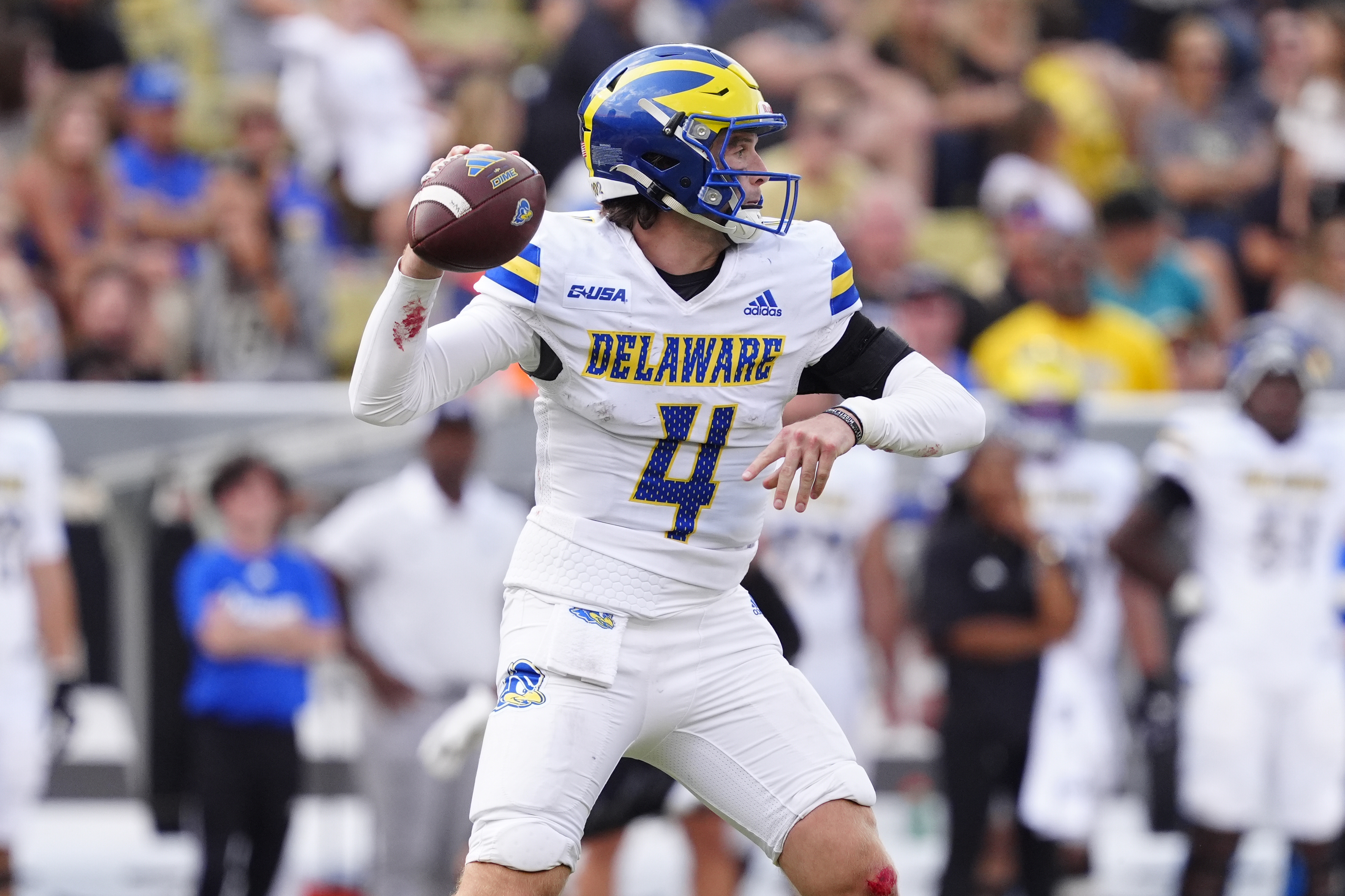 Delaware Fightin Blue Hens quarterback Nick Minicucci (4) prepares to pass the ball as we break down our Louisiana vs. Delaware predictions.
