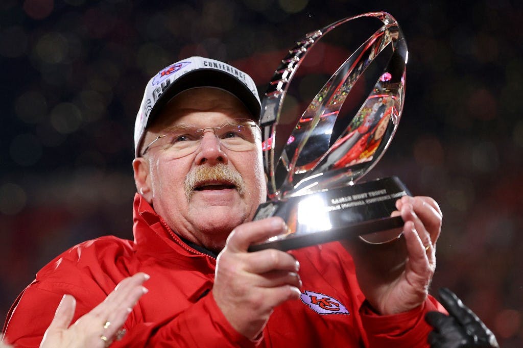Head coach Andy Reid of the Kansas City Chiefs holds up the Lamar Hunt Trophy after defeating the Cincinnati Bengals 23-20 in the AFC Championship Game at GEHA Field at Arrowhead Stadium on January 29, 2023 in Kansas City, Missouri. Photo by Kevin C. Cox/Getty Images via AFP.