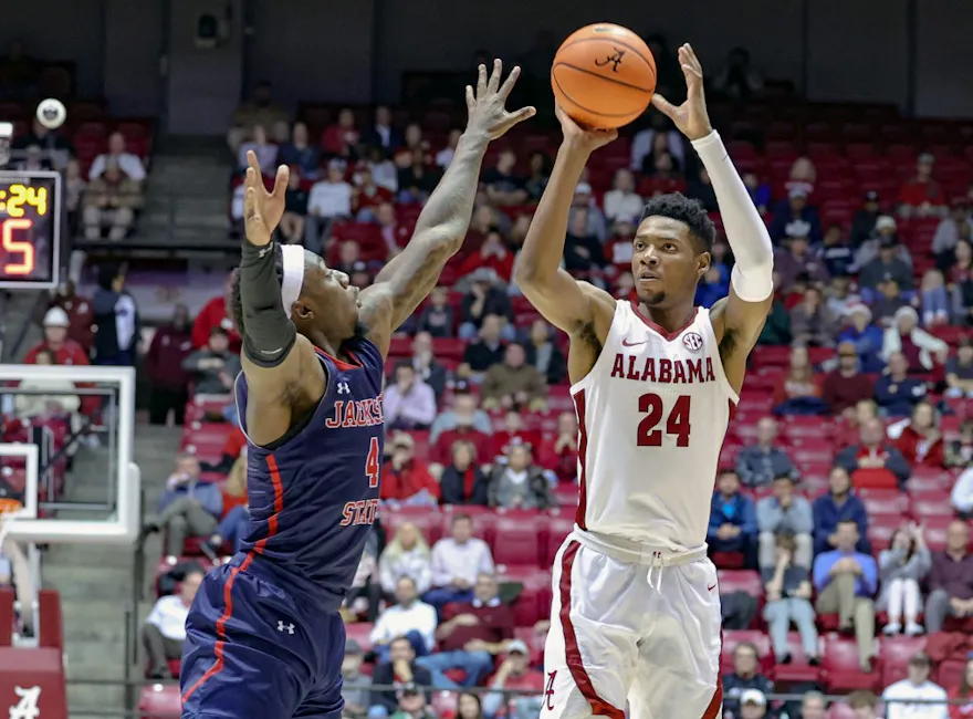 Brandon Miller of the Alabama Crimson Tide puts up a shot over Coltie Young of the Jackson State Tigers at Coleman Coliseum on Dec. 20, 2022 in Tuscaloosa, Alabama. 