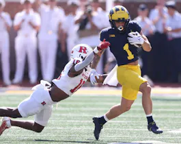 Roman Wilson #1 of the Michigan Wolverines looks for yards after a first half catch as we make our predictions for the 2024 NFL Draft Combine odds and props.